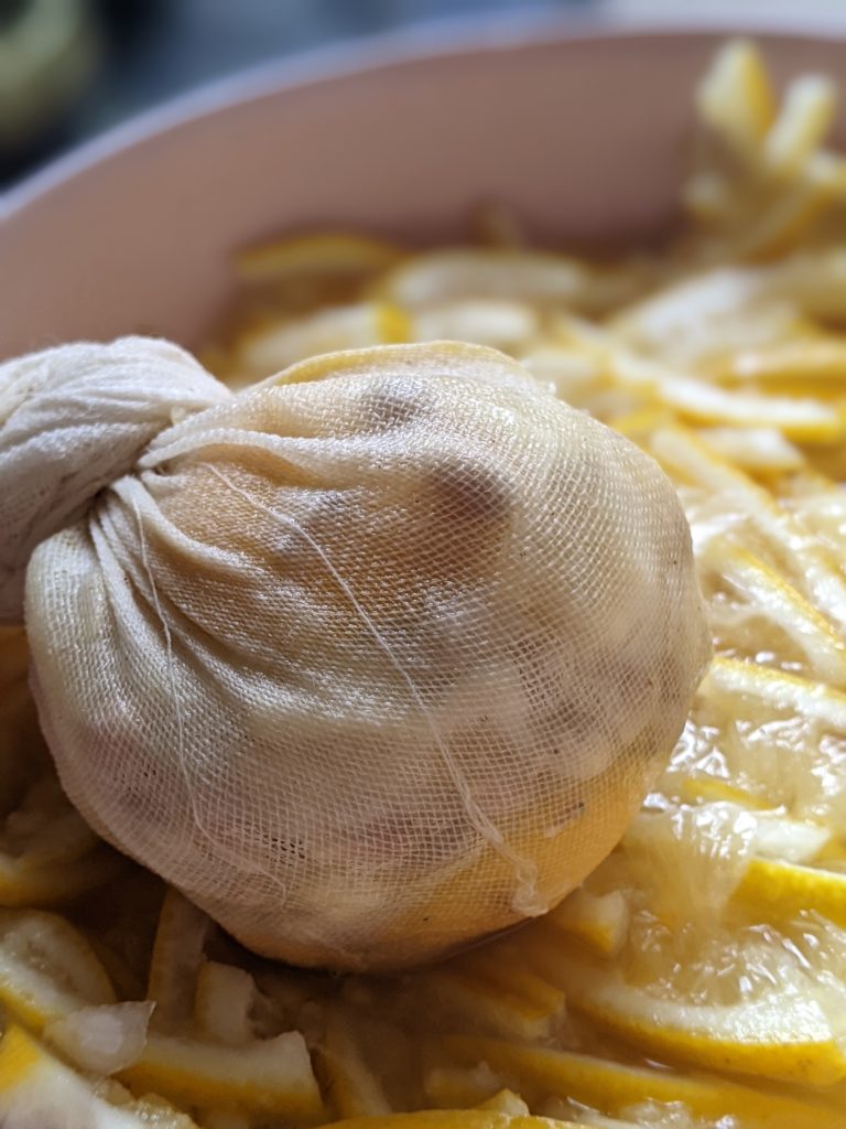 cheesecloth holding seeds, pith and membranes for homemade marmalade